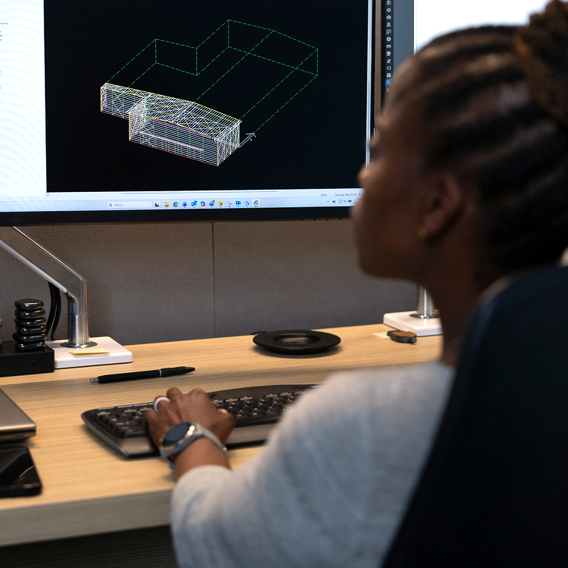 Image of woman seated at desk using VP Command software. 